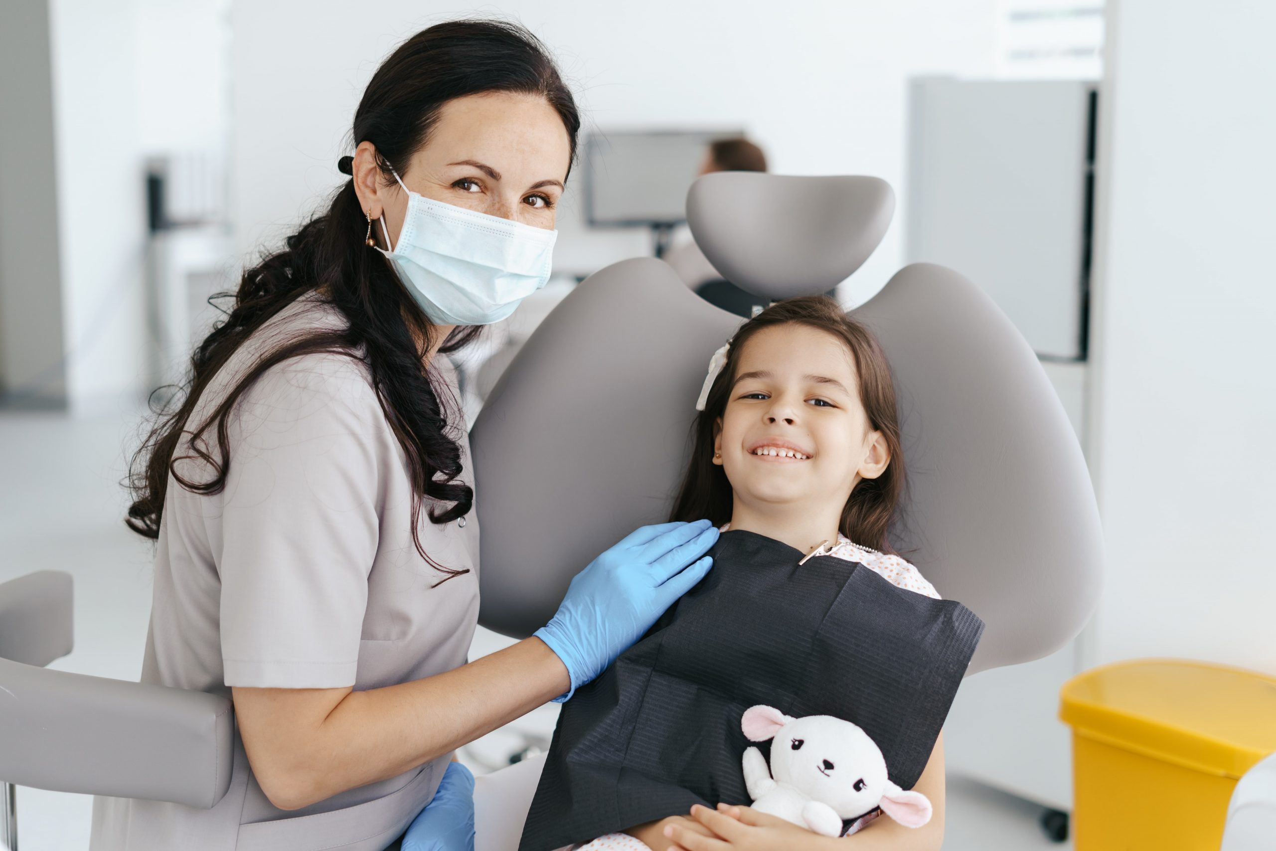 little-beautiful-girl-dentist-looking-smiling-min-scaled
